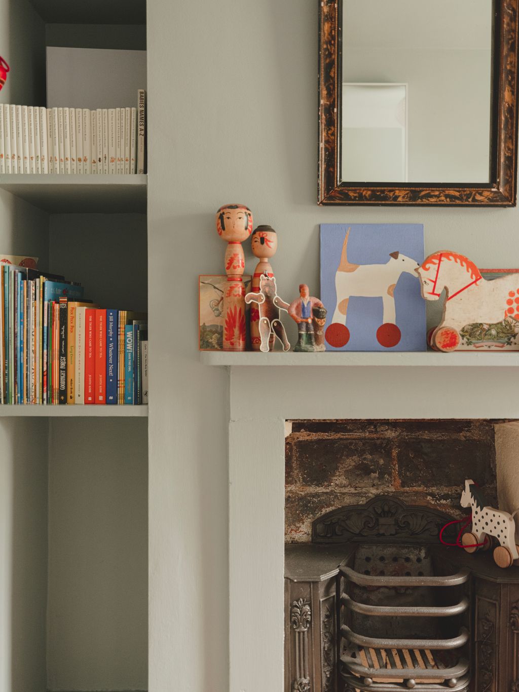 Image may contain Furniture Shelf Bookcase Person Art Painting and Chair