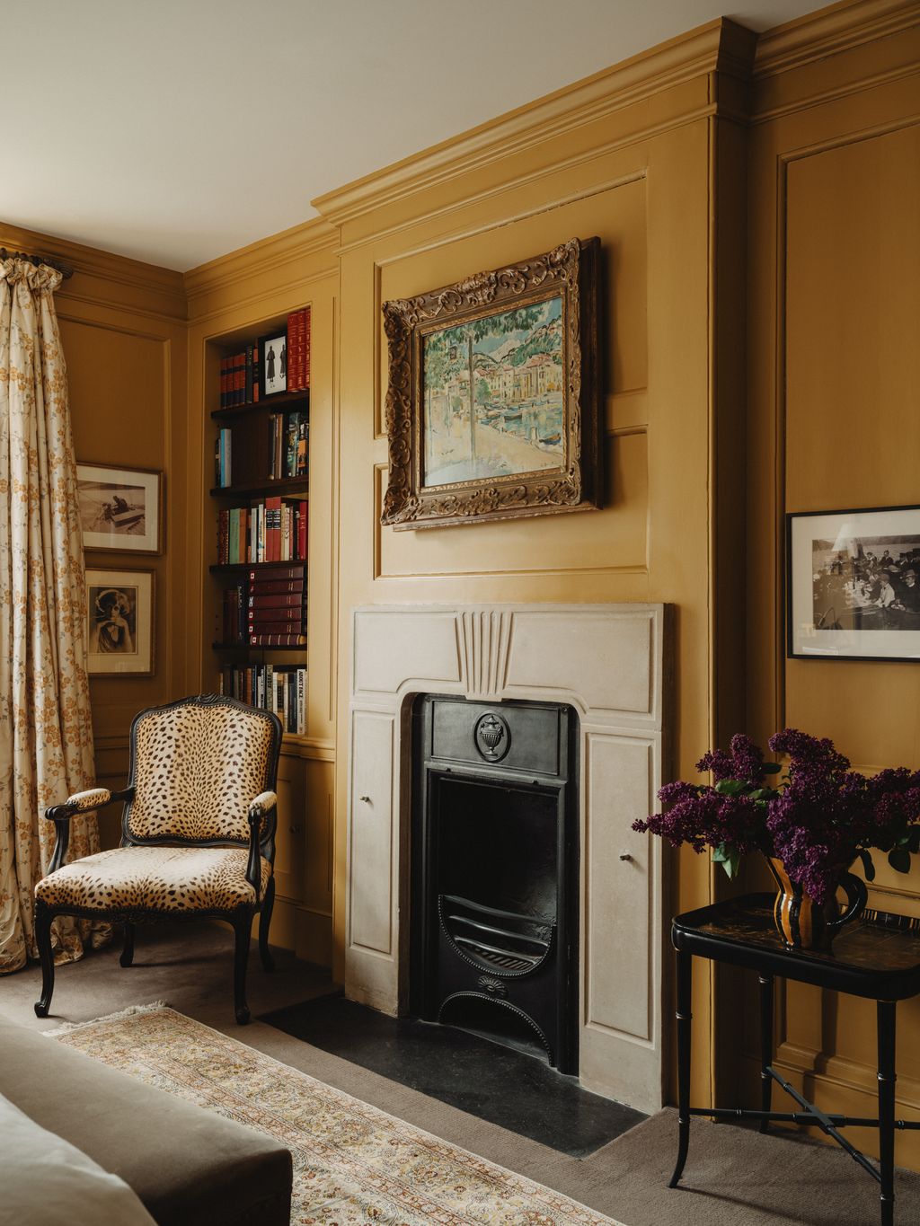 Image may contain Indoors Interior Design Chair Furniture Home Decor Art Painting Fireplace Rug Desk and Table