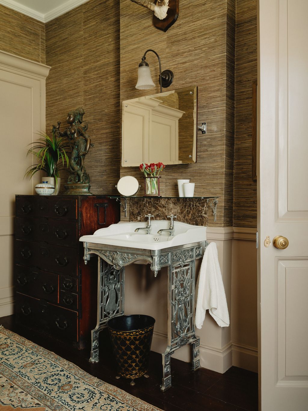 Image may contain Indoors Interior Design Lamp Sink Sink Faucet Plant Person Cup Home Decor Rug and Corner