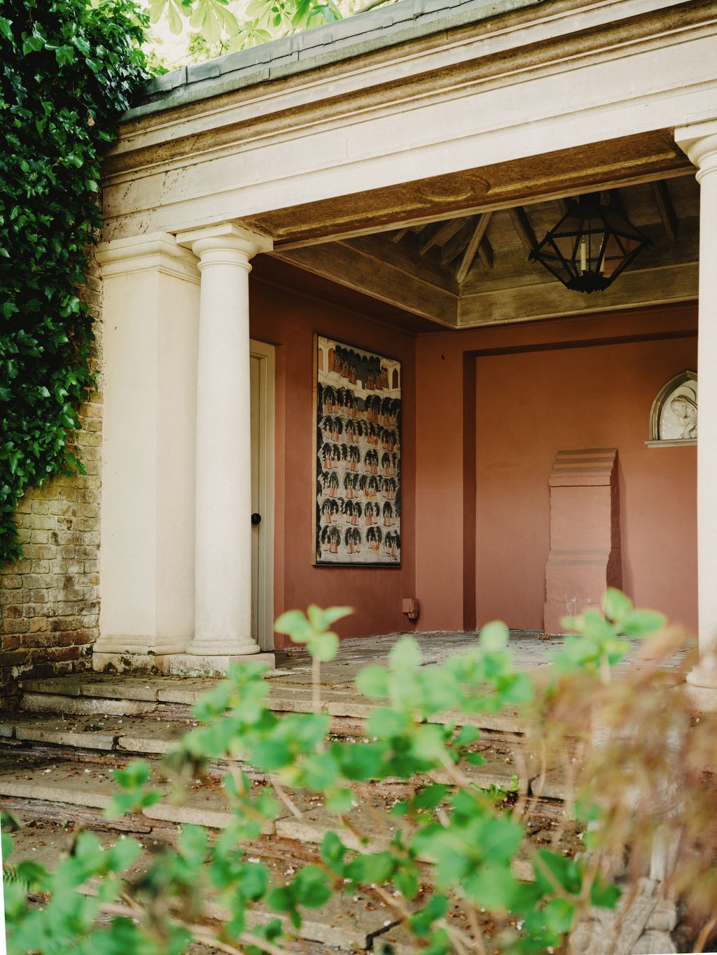 Image may contain Architecture Building House Housing Portico Herbal Herbs Plant Lamp Porch Monastery and Art