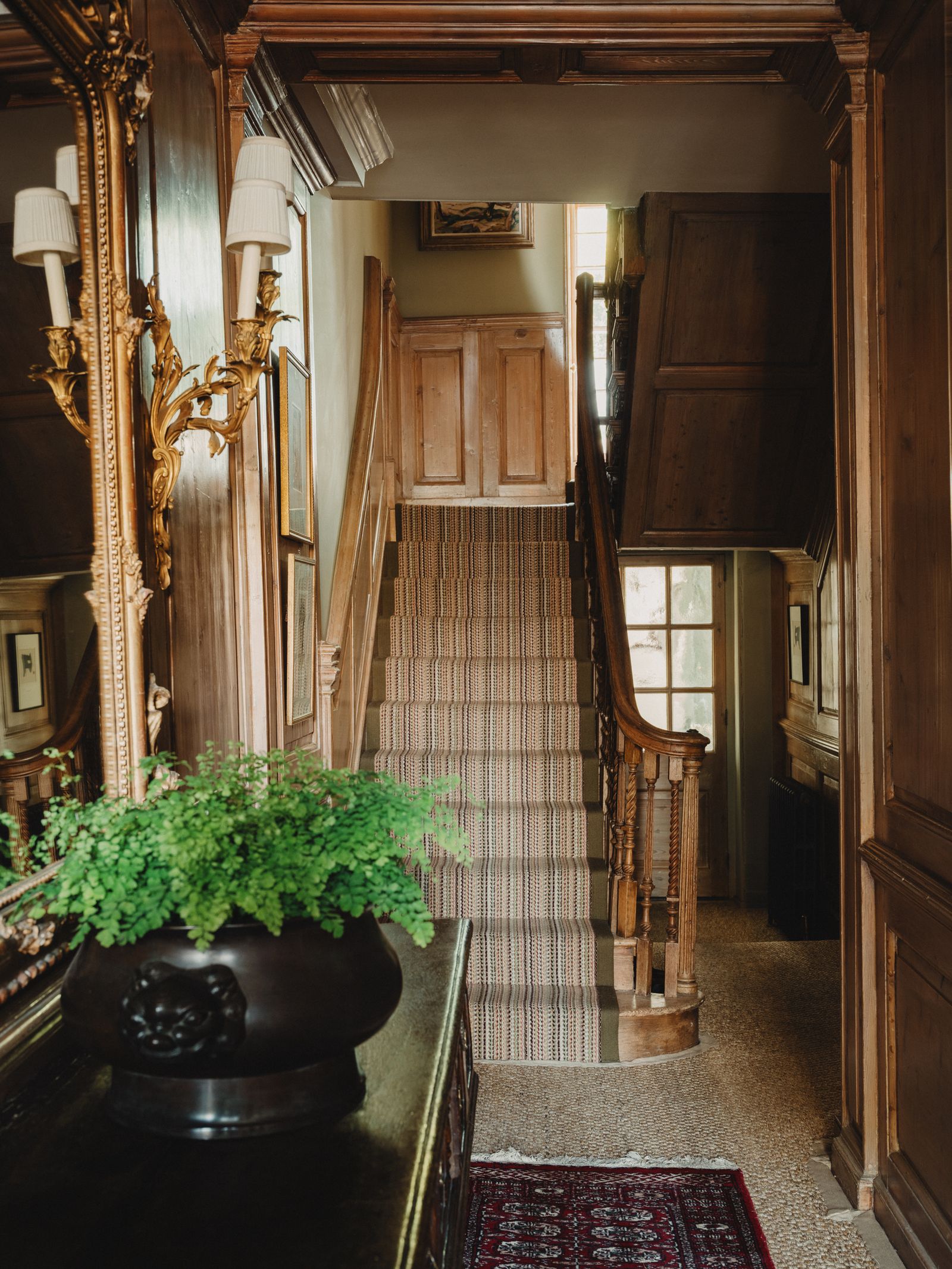 Image may contain Indoors Architecture Building Foyer Home Decor Rug Plant Art Painting Interior Design and House