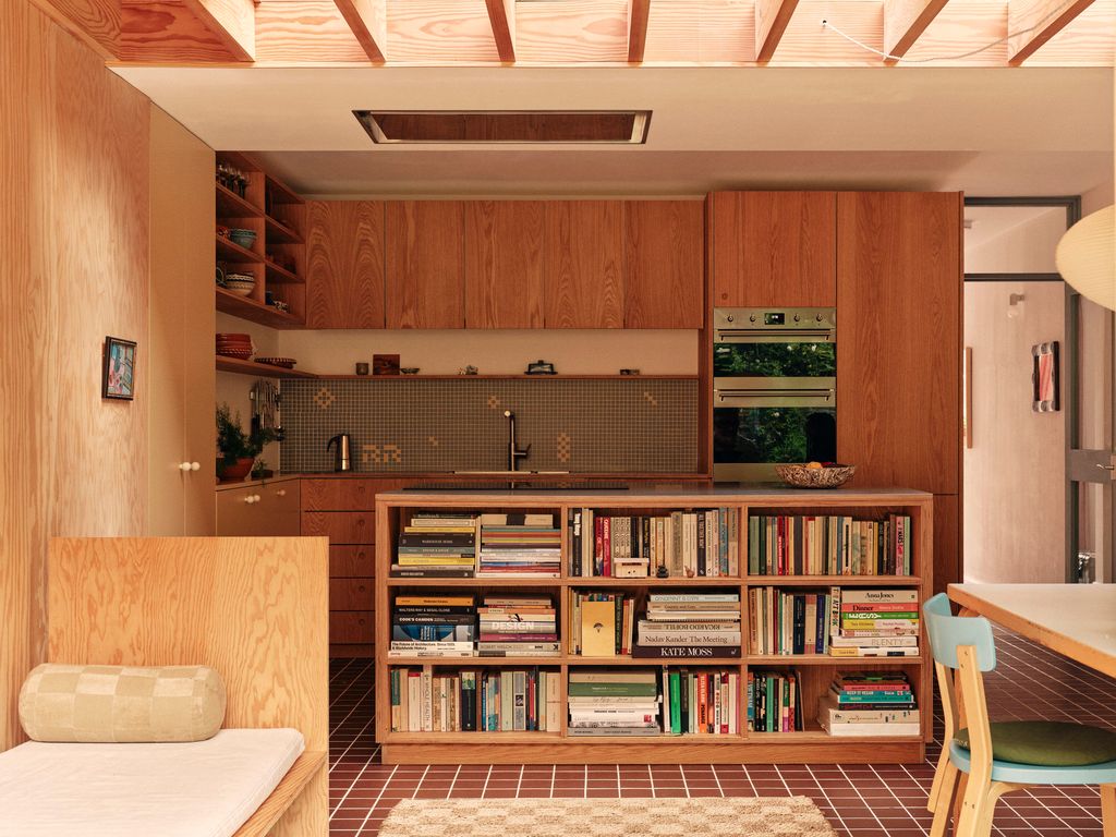 Image may contain Indoors Interior Design Chair Furniture Wood Plant Home Decor Rug Art Painting and Bookcase