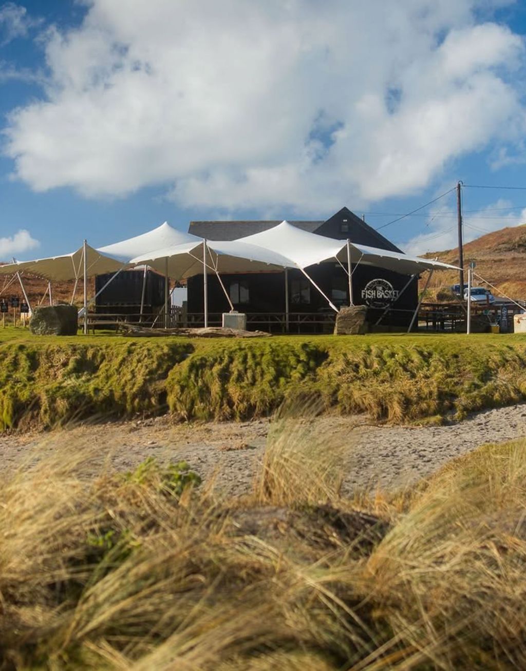 Image may contain Architecture Building Outdoors Shelter Grass Plant Nature Sky Car Transportation and Vehicle