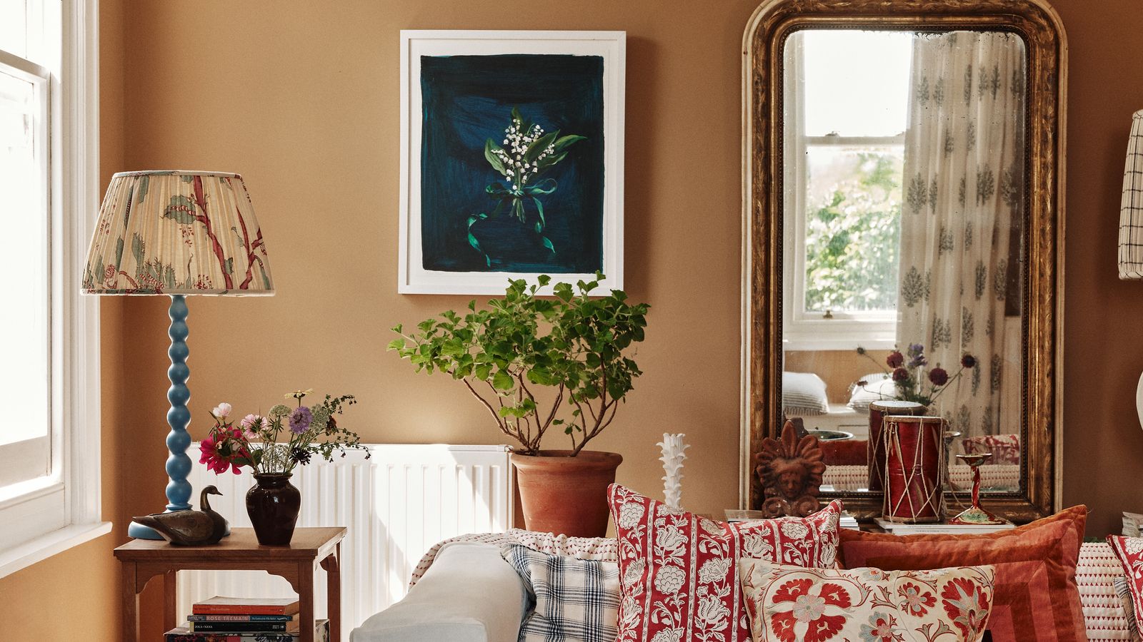 Image may contain: Home Decor, Cushion, Plant, Lamp, Couch, Furniture, Architecture, Building, Indoors, Living Room, and Room