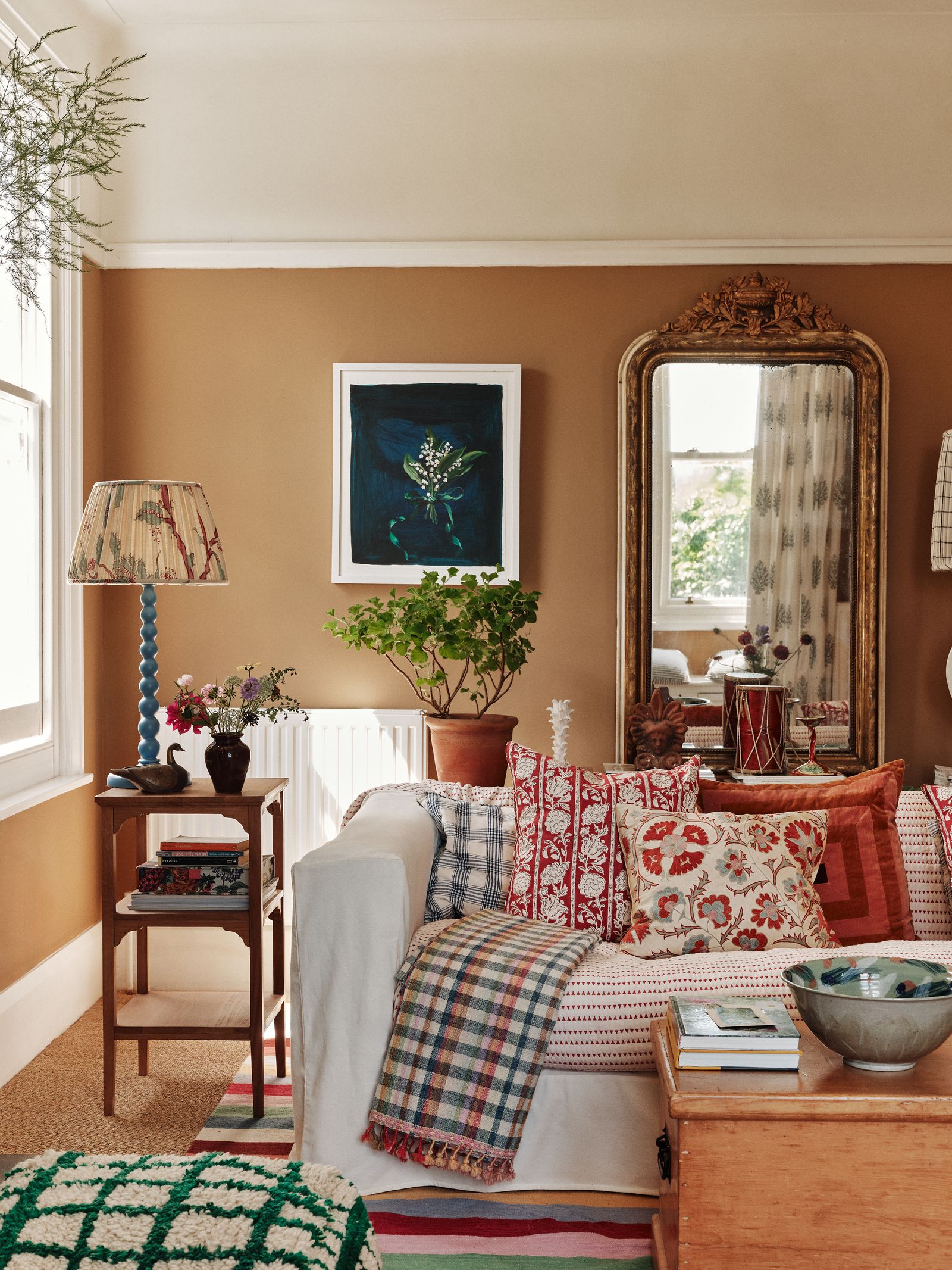 Image may contain Home Decor Cushion Plant Lamp Couch Furniture Architecture Building Indoors Living Room and Room