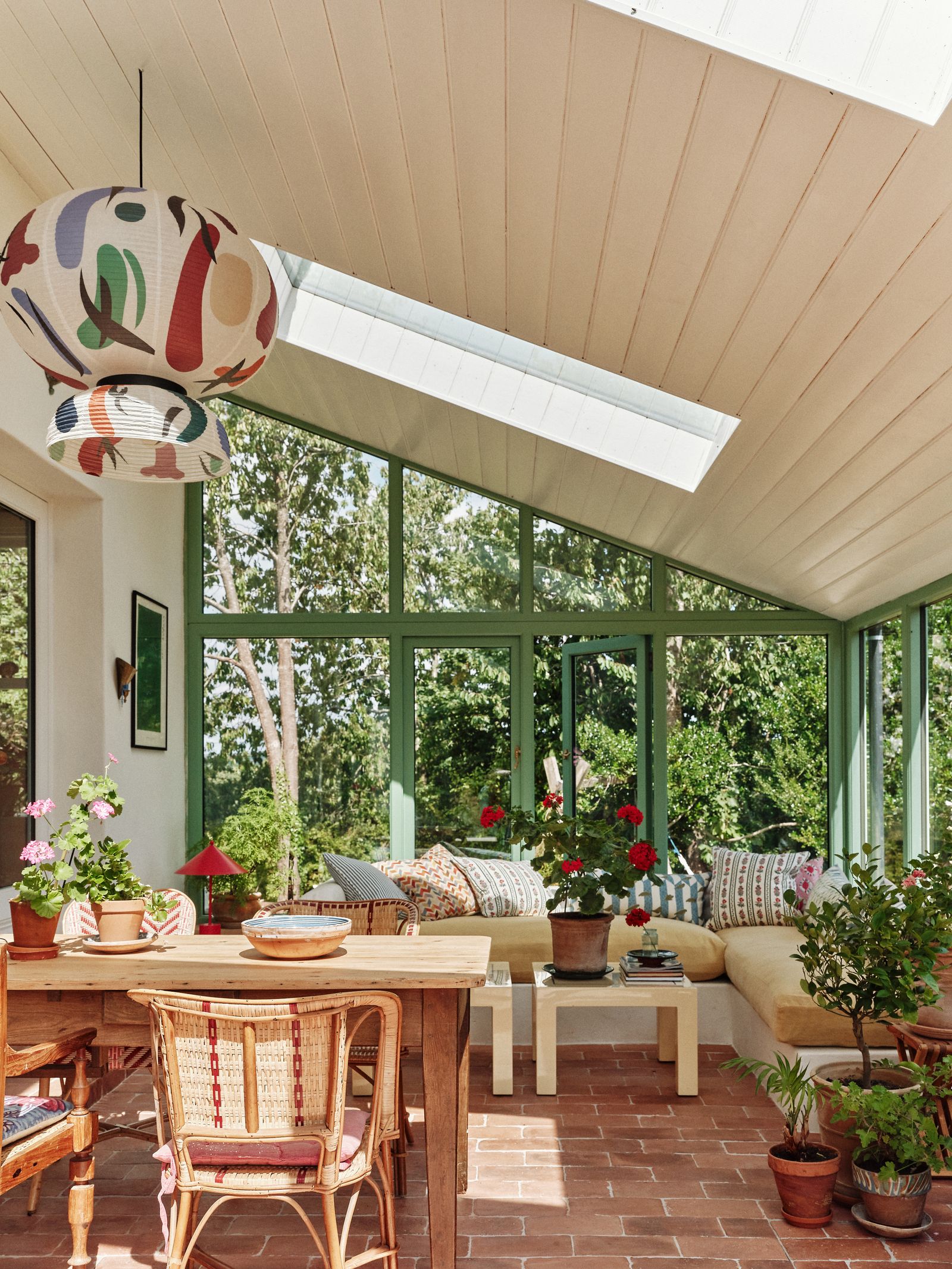 Image may contain Indoors Interior Design Plant Chair Furniture Art Painting Home Decor Lamp Window and Table