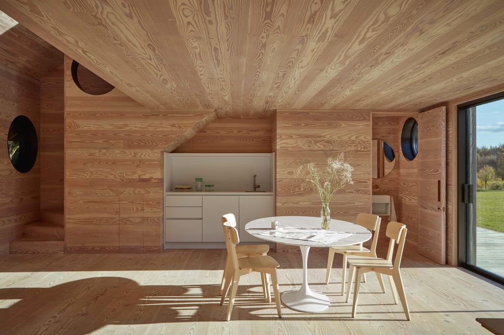 Image may contain Indoors Interior Design Wood Panels Wood Desk Furniture Table Chair Hardwood and Stained Wood