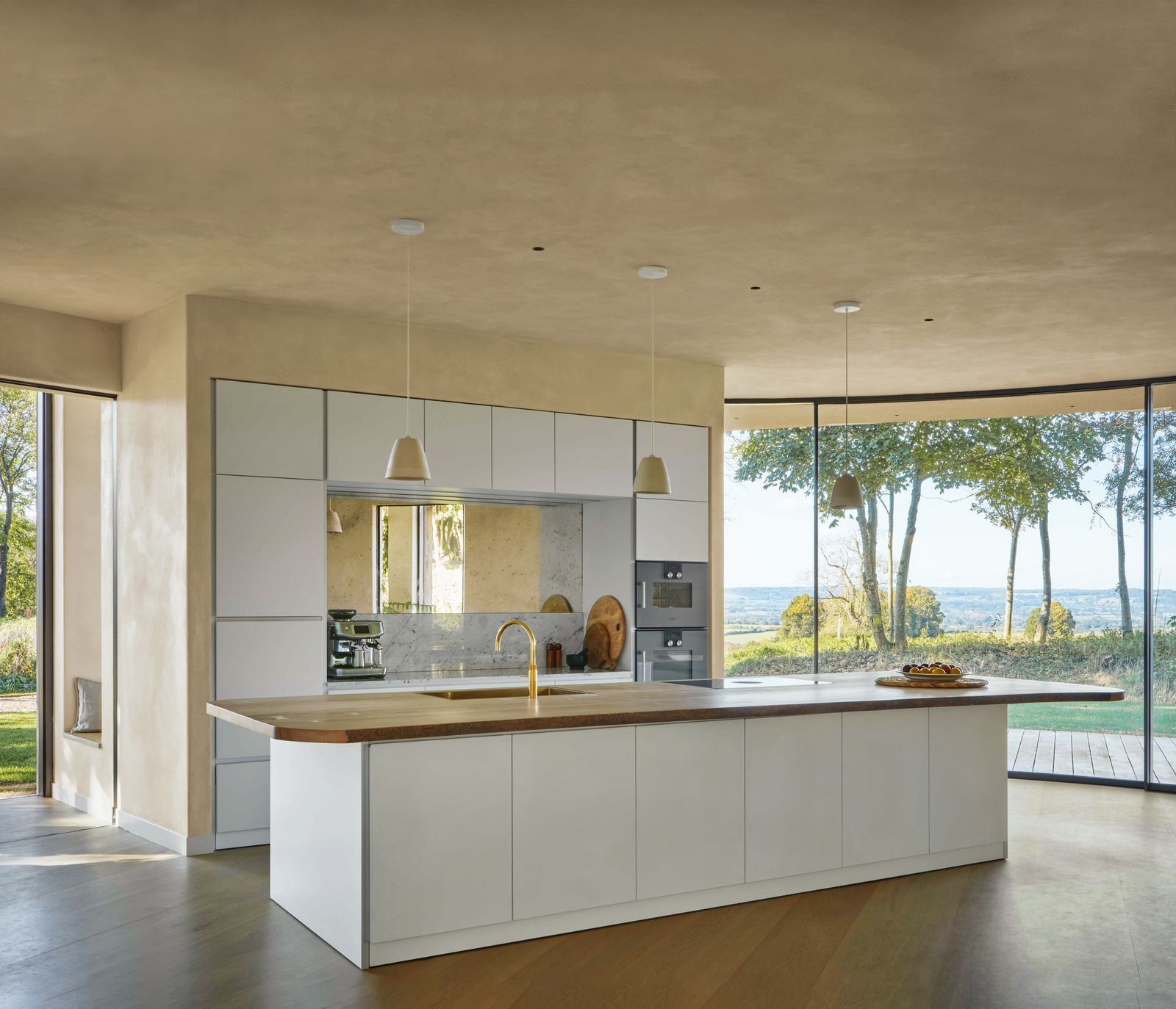 Image may contain Indoors Interior Design Kitchen Kitchen Island Sink Sink Faucet Lamp and Home Decor