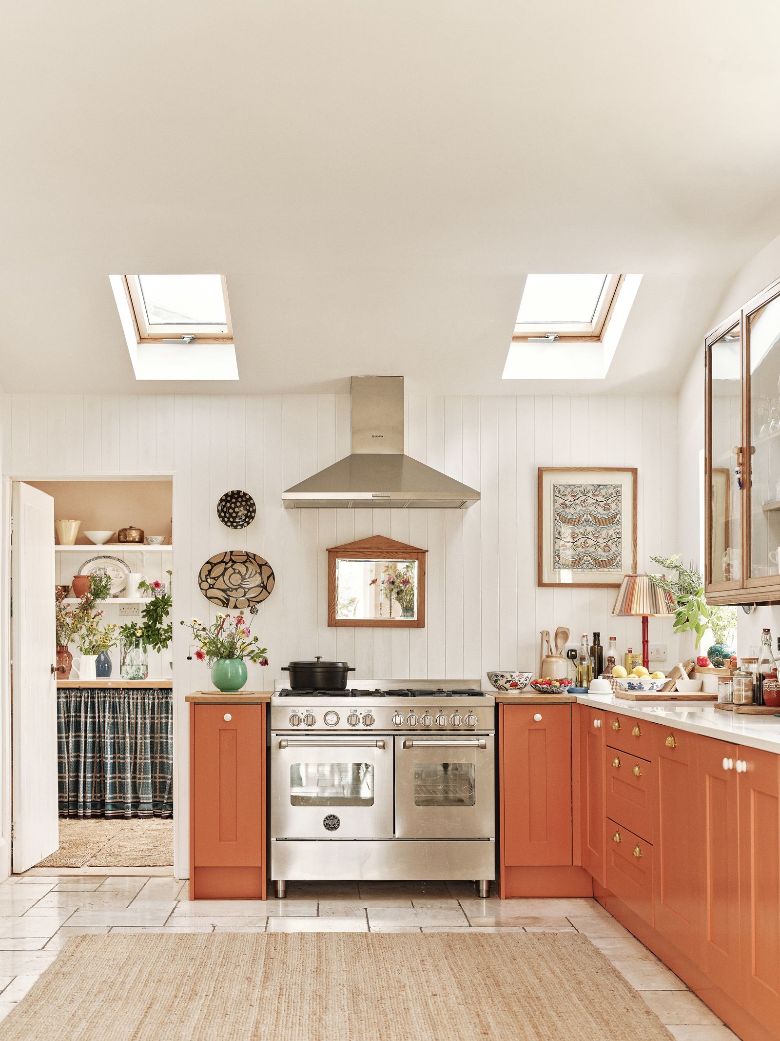 Image may contain Indoors Kitchen Interior Design Lamp Art Painting Home Decor Rug Window Cooktop and Architecture