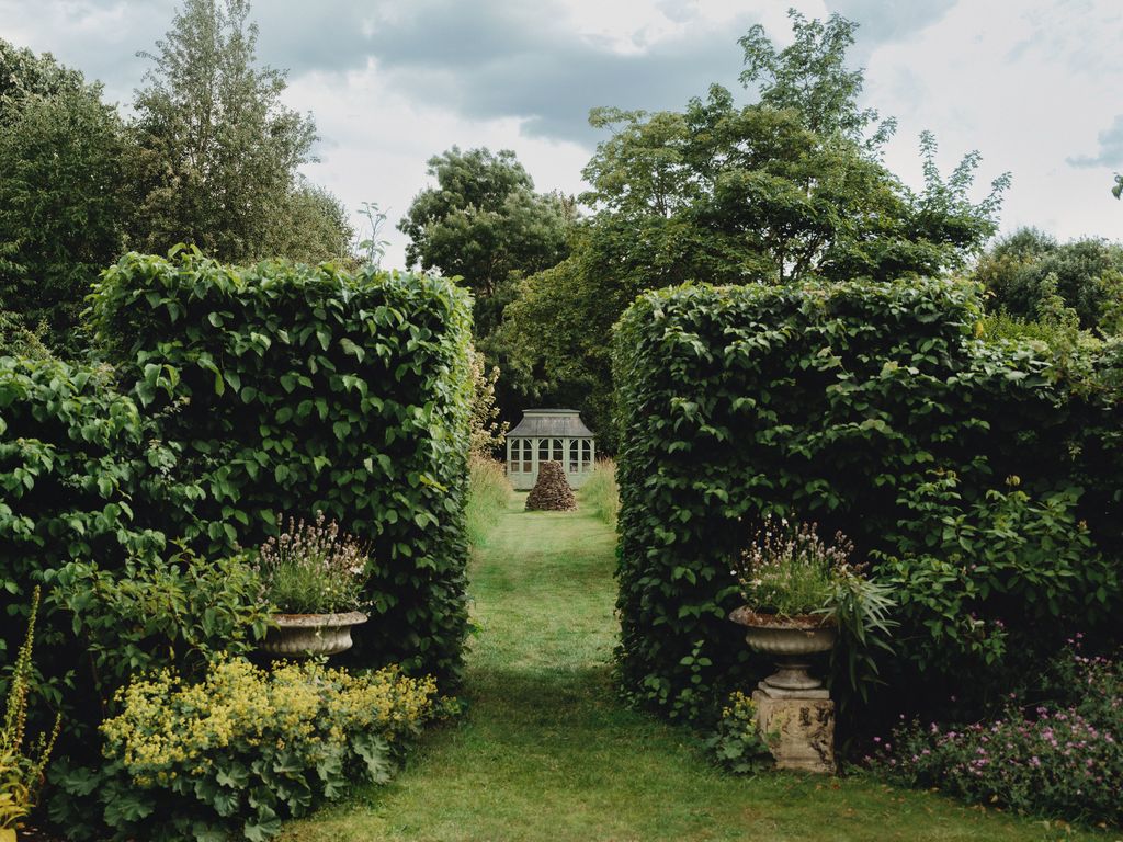 A ‘Braemar summerhouse by HSP Garden Buildings stands in the garden.