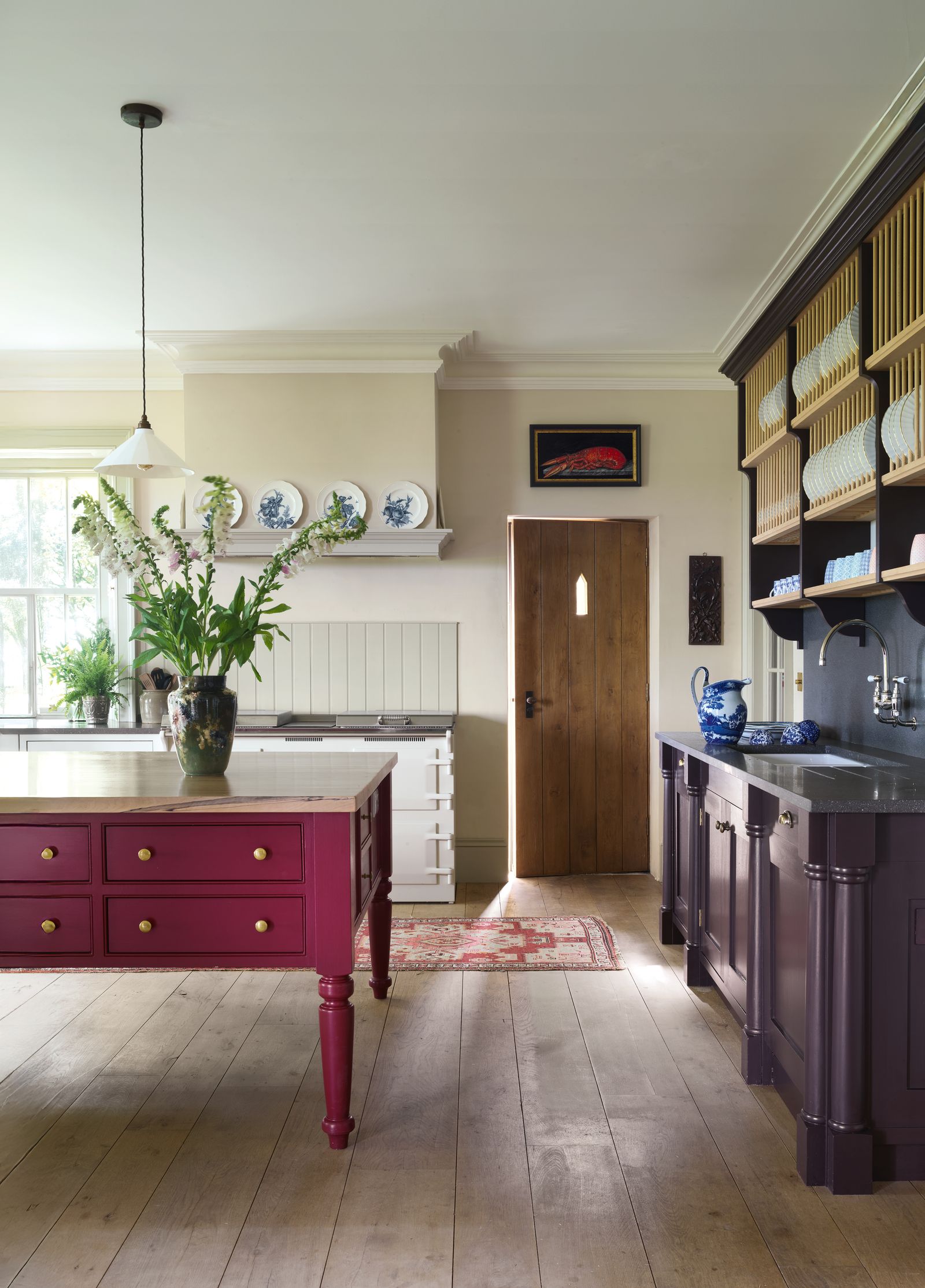 The large preparation table in the kitchen painted in ‘Murrey Red by Papers and Paints and the plate rack were inspired...