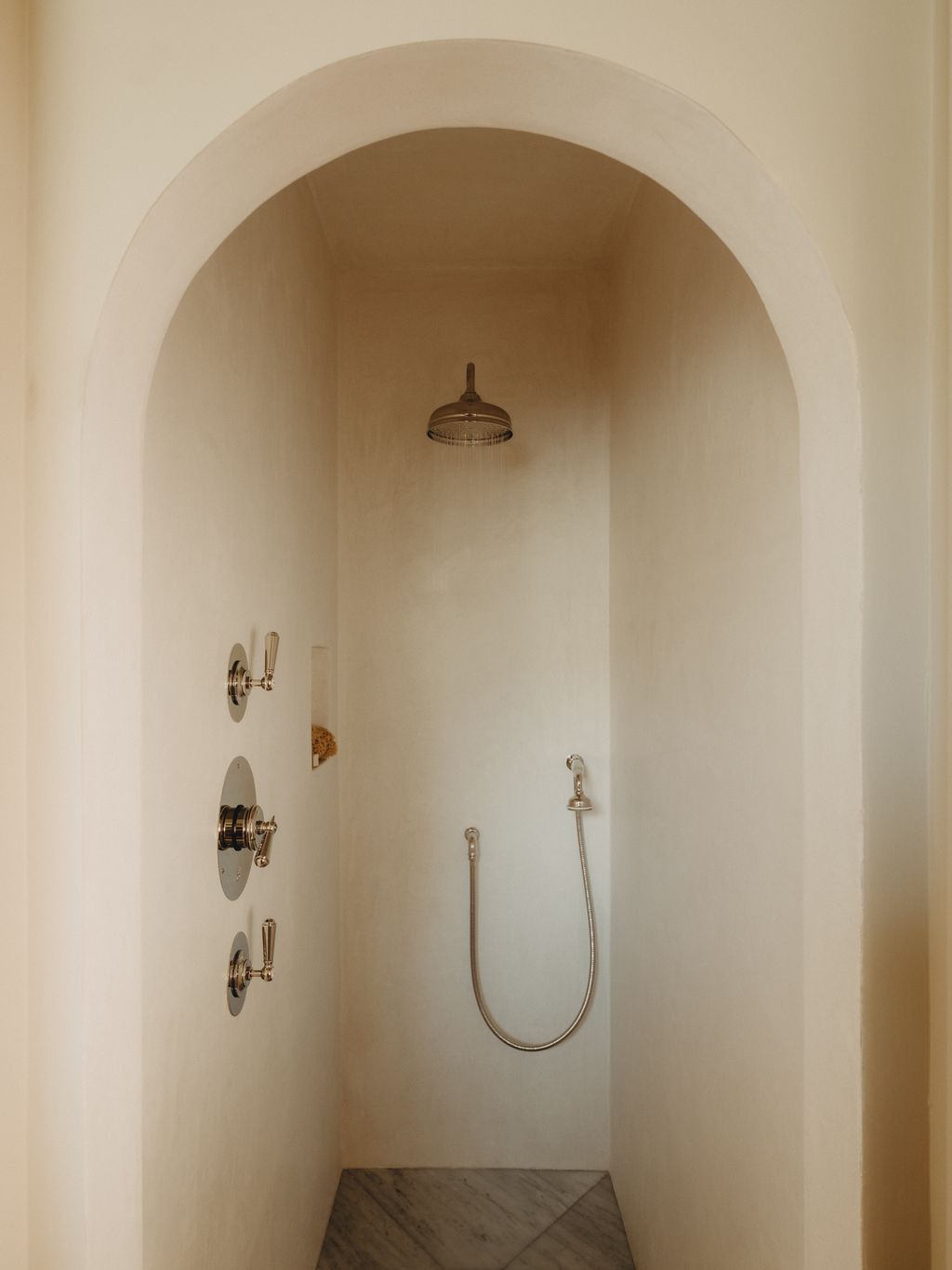 The shower was lined in tadelakt by the local plasters Cotswold Bespoke Interiors. The fixtures are by Barber Wilsons.