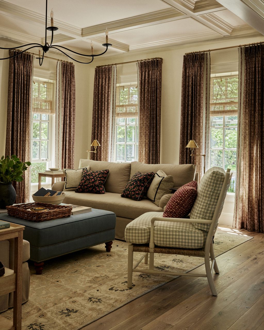 In the family room is a layered window treatment consisting of Lisa Fines linen ‘Paradeiza curtains in ‘coco and blinds...