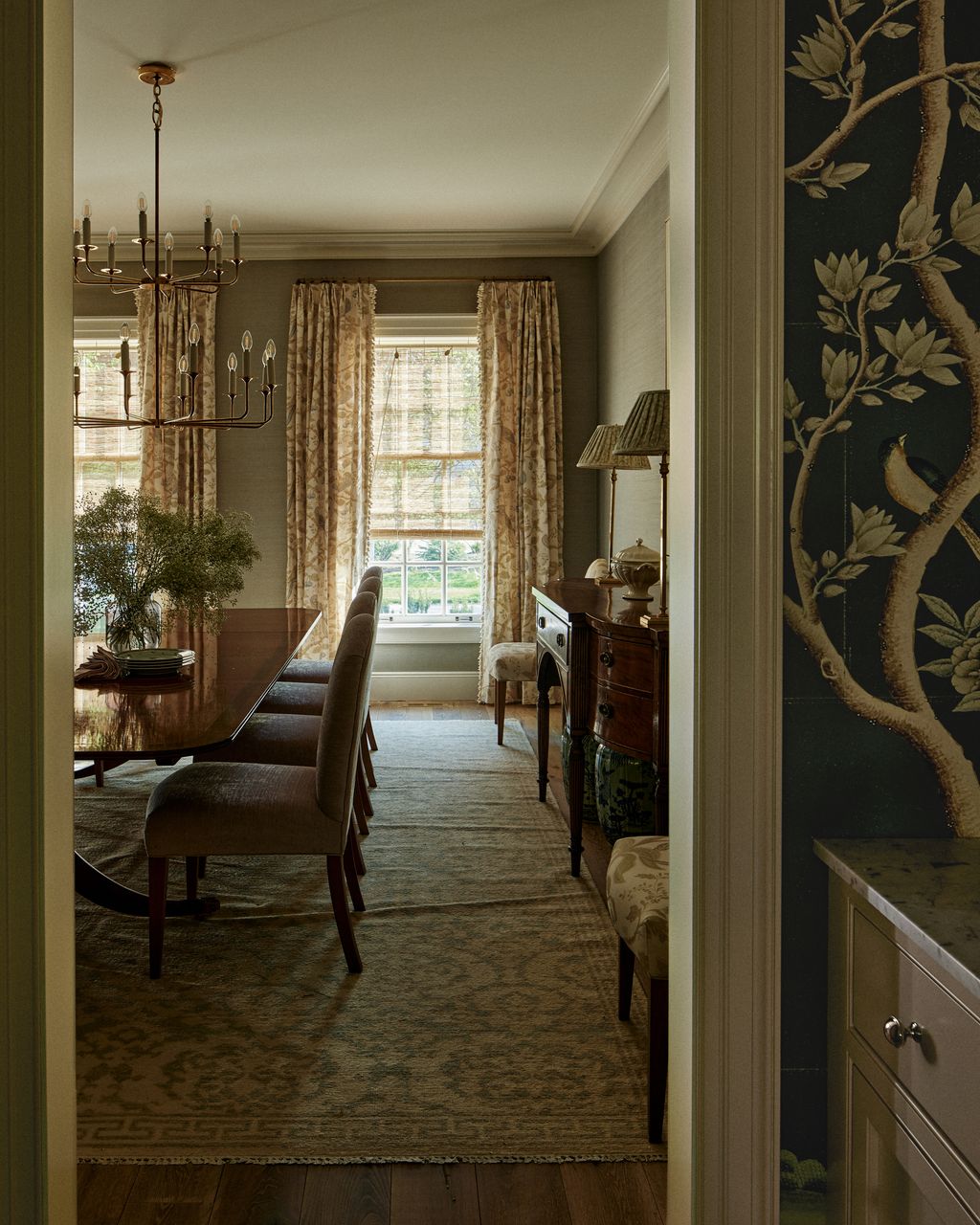 The antique Duncan Phyfe dining table is accompanied by custom chairs made by Whittington  Company and upholsted in...