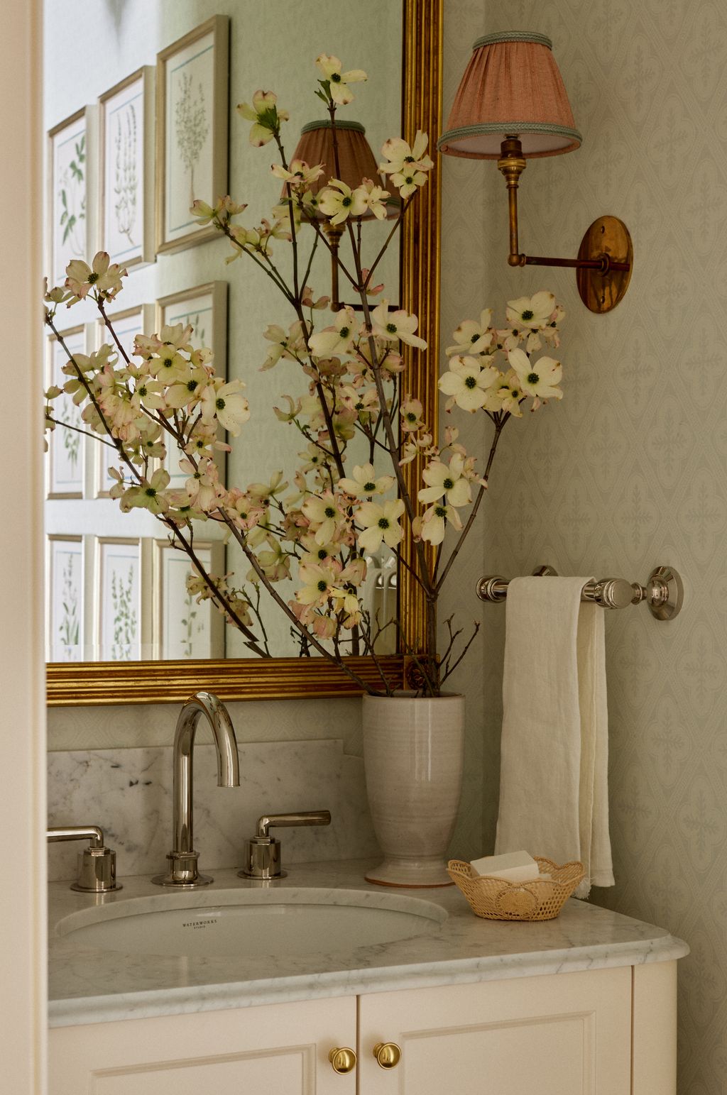 The vanity in the powder room was made bespoke by Whittington  Company. A mirror by Scully and Scully hangs above it....