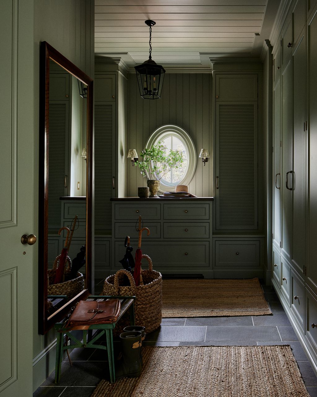 Painted in Farrow  Ball's ‘French Grey and having a little less natural light the boot room has a hushed cocooning...