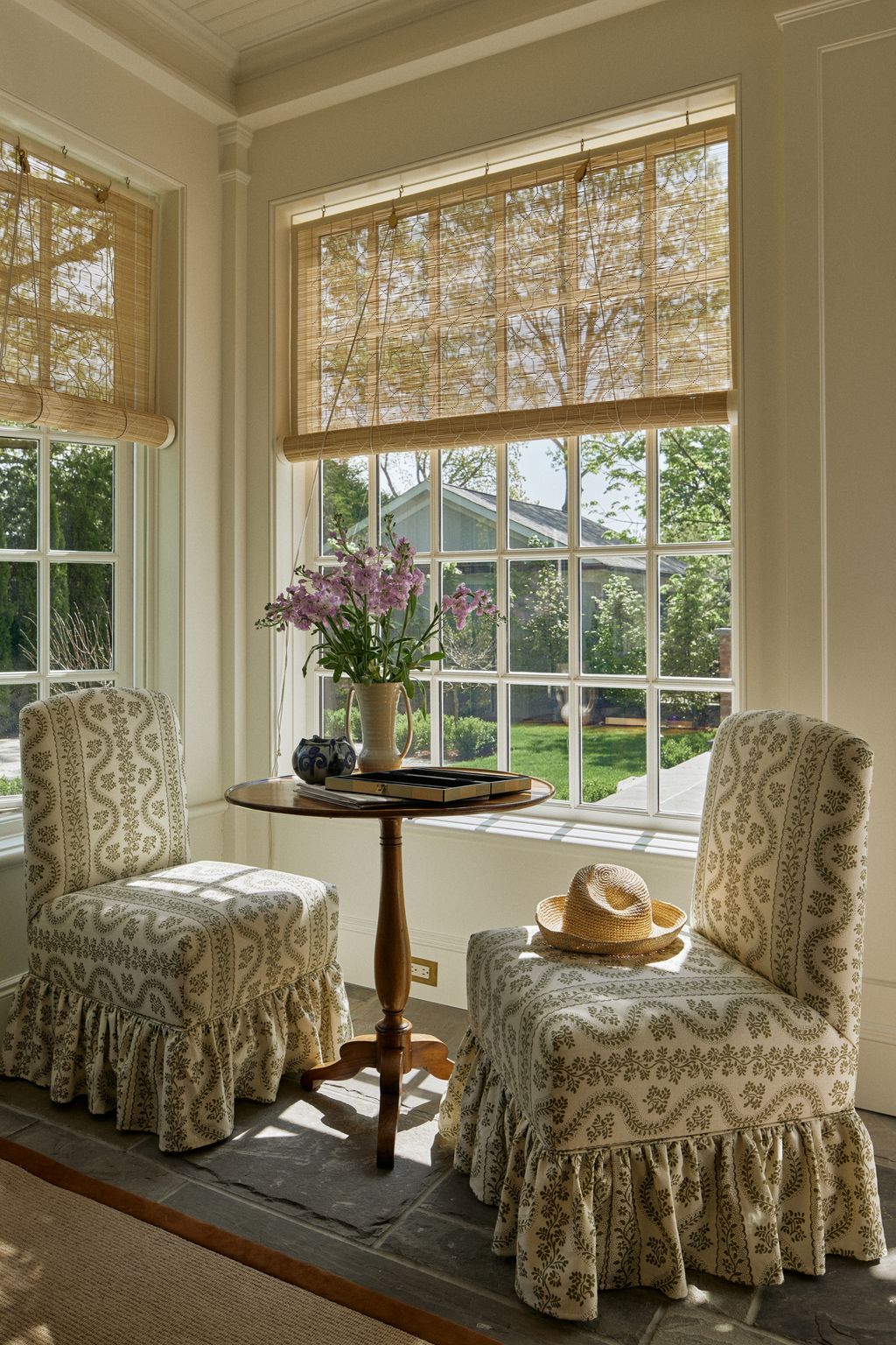 These matching chairs by the window in the sun room are upholstered in ‘Dolly a floral print fabric by Sister Parish in...
