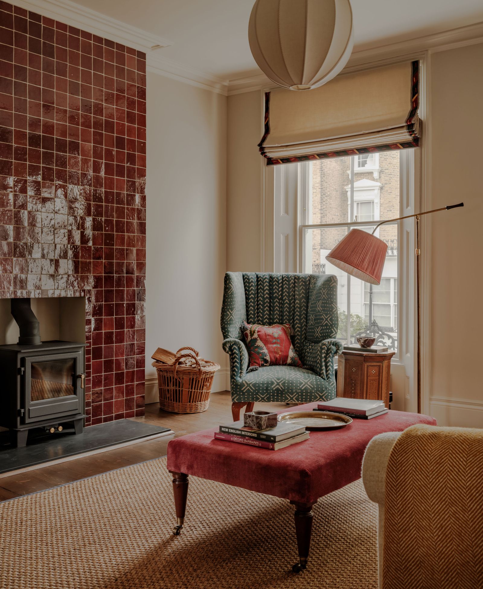 A floortoceiling tiled living room chimney breast featuring burgundy zellige tiles and crafted in Fez by Habibi is...