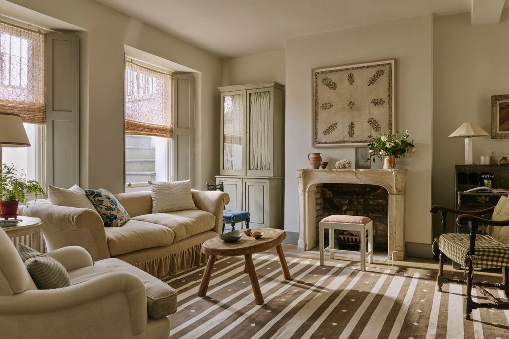 The sofa is a 19thcentury piece upholstered in a hand dyed loose linen cover. The rug is from Etsy which warms up this...