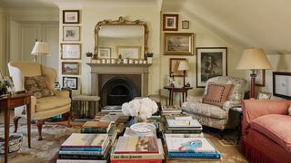 The sitting room takes up half of the loft conversion upstairs. On the left a Queen Anne wing chair is covered in a...