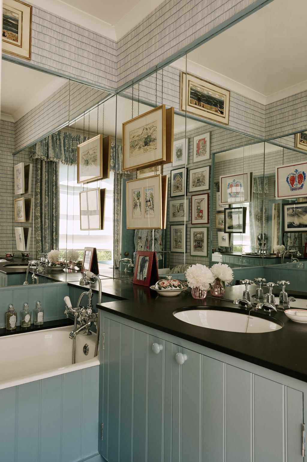 The little ensuite bathroom is made to feel larger thanks to the addition of a bright blue patterned wallpaper ‘Crochet...