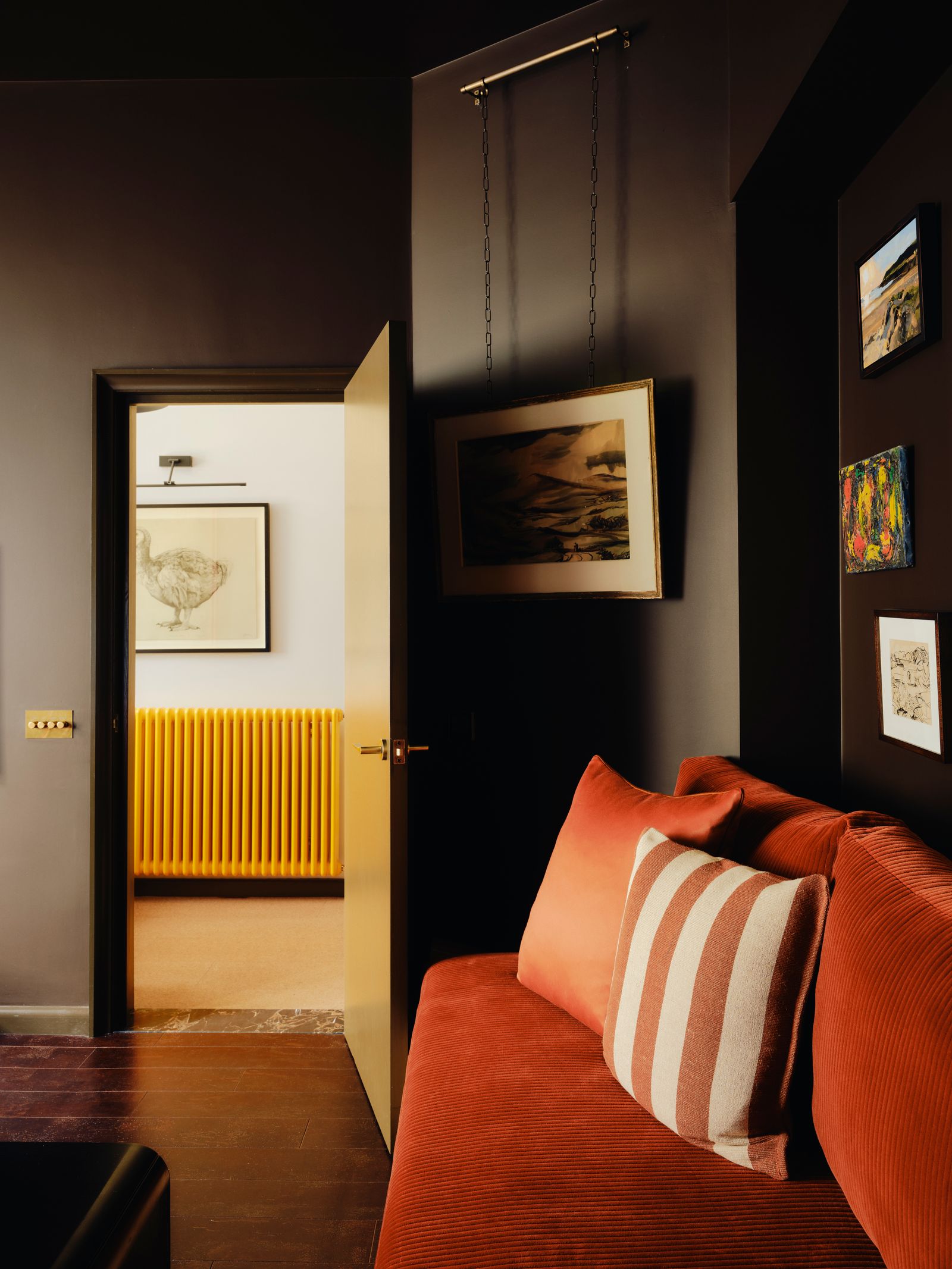 A Rosso Levanto marble threshold from Stone Age is paired with a Castrads Florence radiator. On the wall Tammy MacKays...