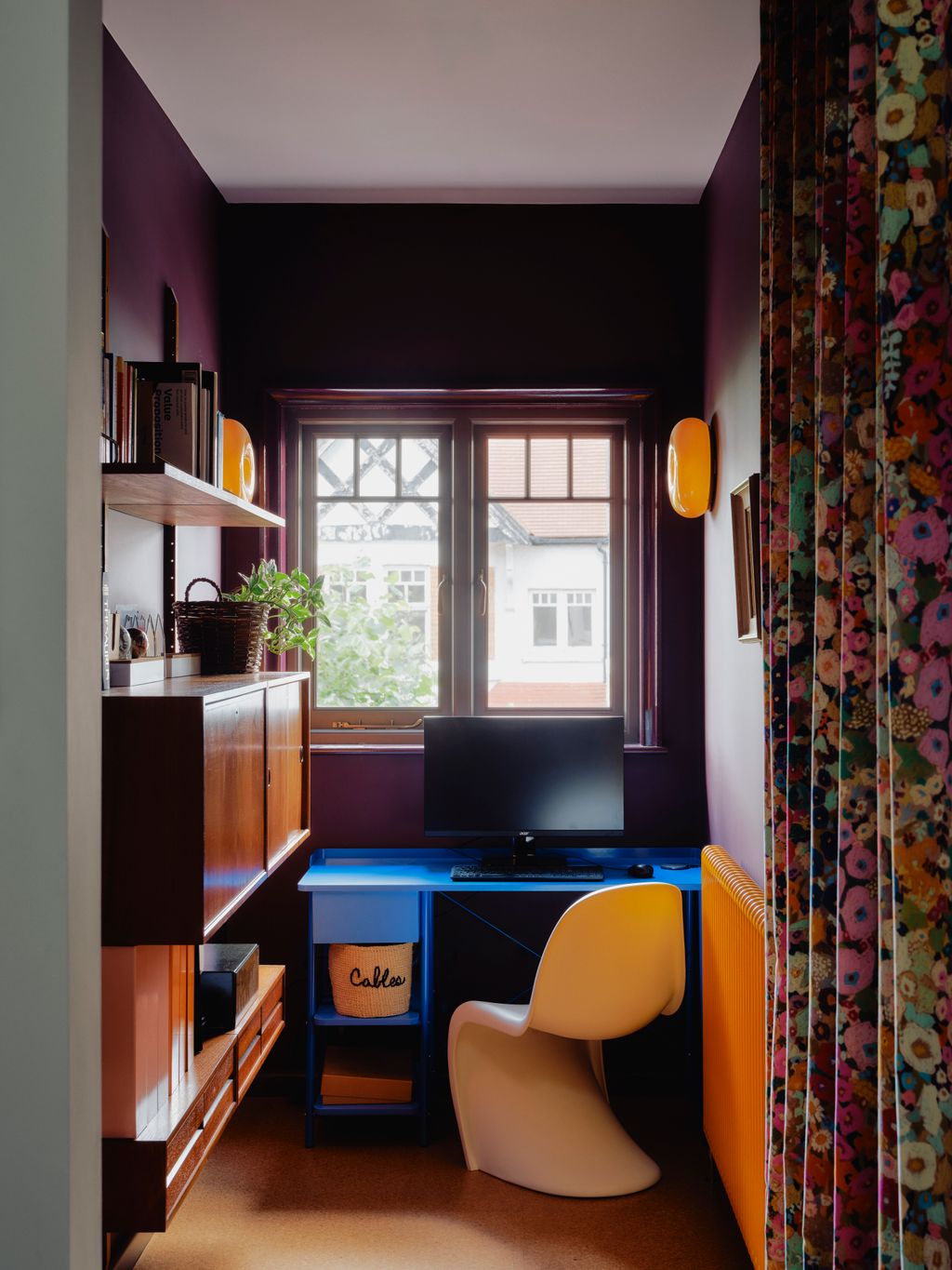 In this study space Ikea Donut wall lights stand out against walls in Farrow  Balls ‘Brinjal. A Maisie desk sits beside...