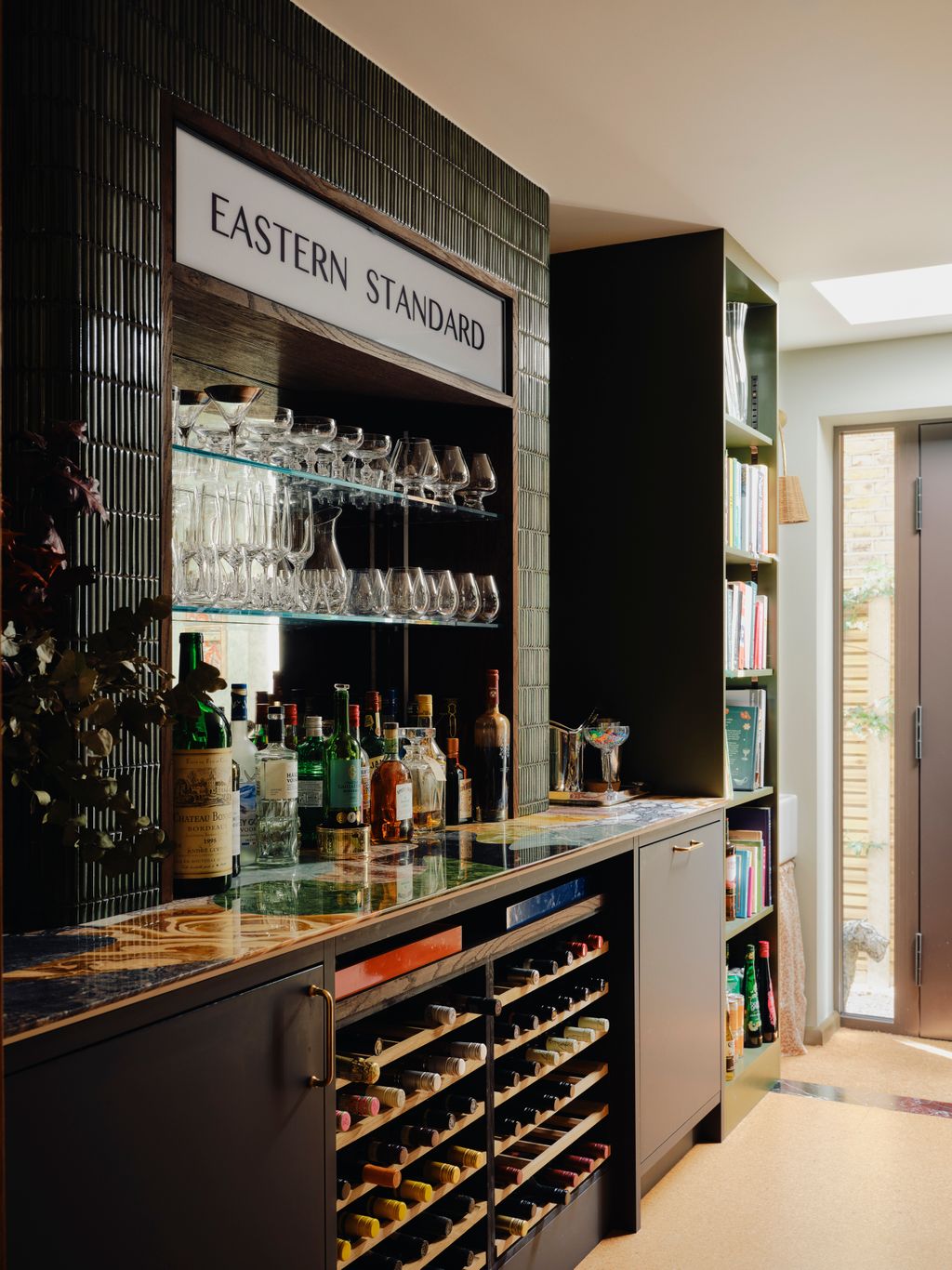 The bar is designed to feel playful with a jigsaw worktop made from marble offcuts by Stone Age and a curved counter...