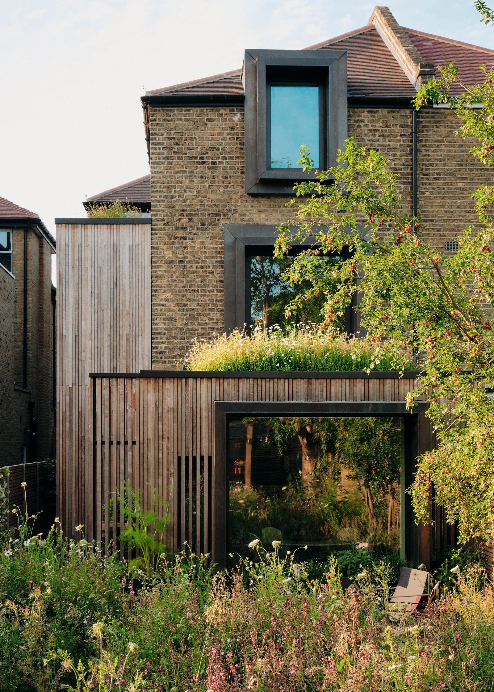 Looking back at the house the southfacing façade features copperclad windows whose projection reduces solar gain with...