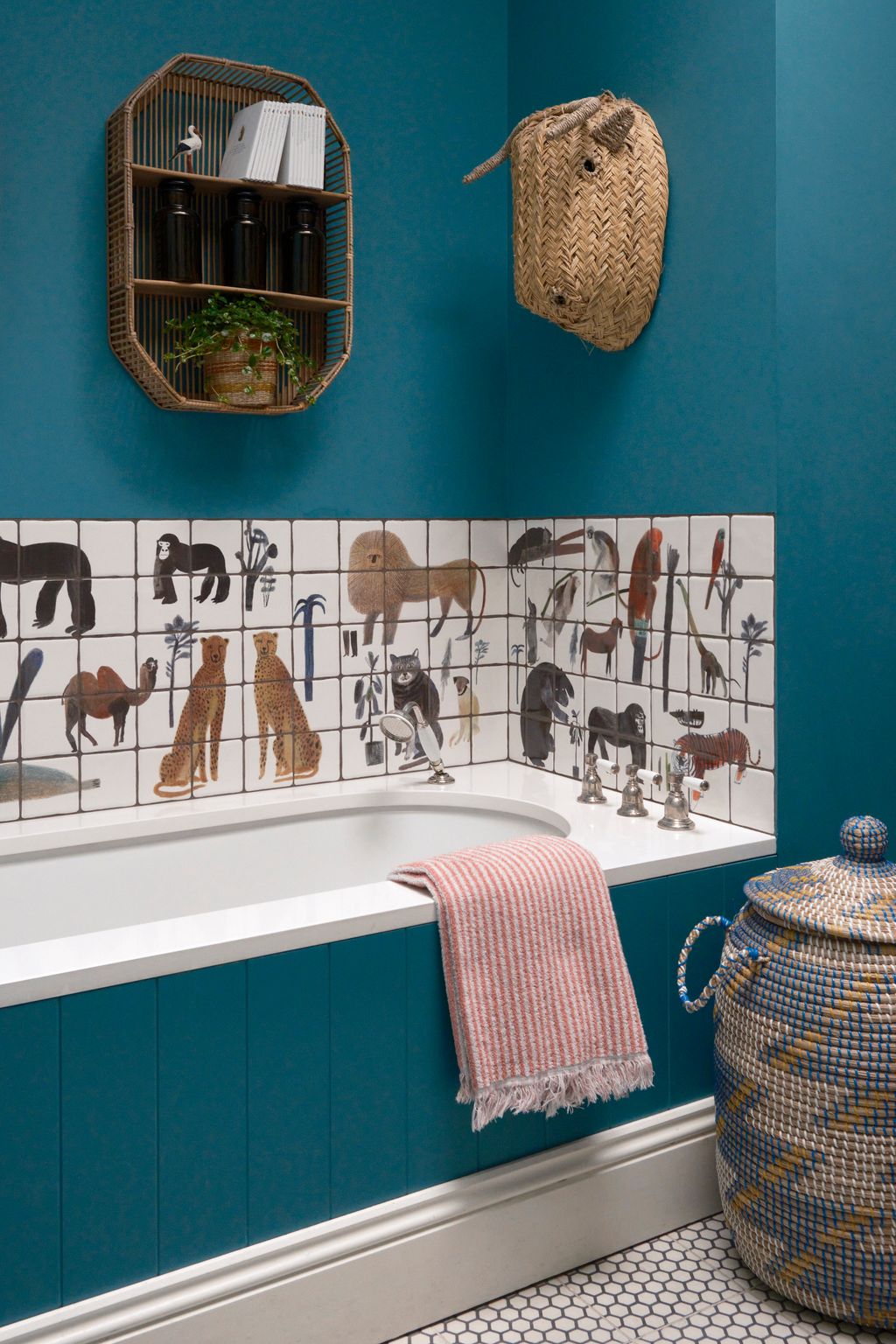 Walls in ‘Vardo by Farrow  Ball and handpainted tiles by Laura Carlin give the childrens bathroom a lively playful feel.