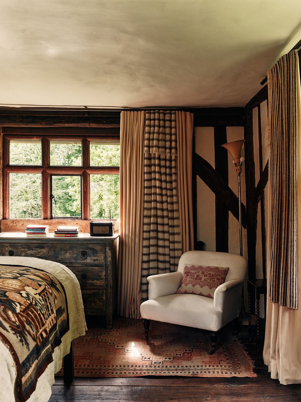 The original wide oak floorboards are softened by a vintage rug from Larusi