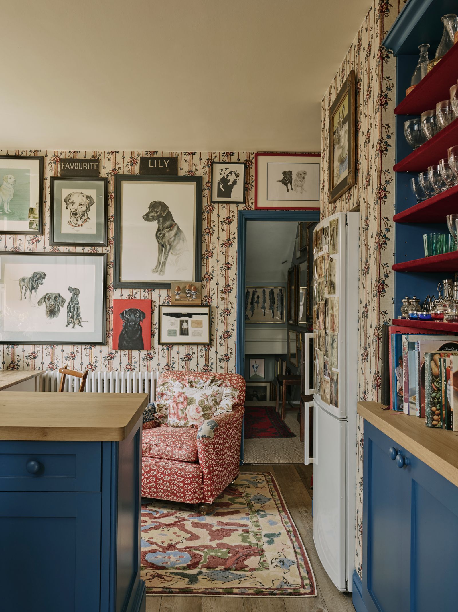Portraits of Cindy's pets over the years are hung on the walls. On the floor is one of Cindy's rugs with Shame Studios.