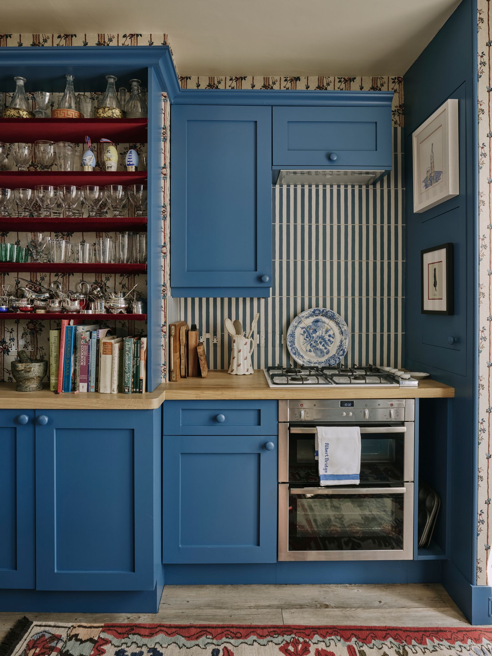 The pinstripe blue tiles are from Your Tiles. The shelves on the left hold Cindy's collection of glassware.