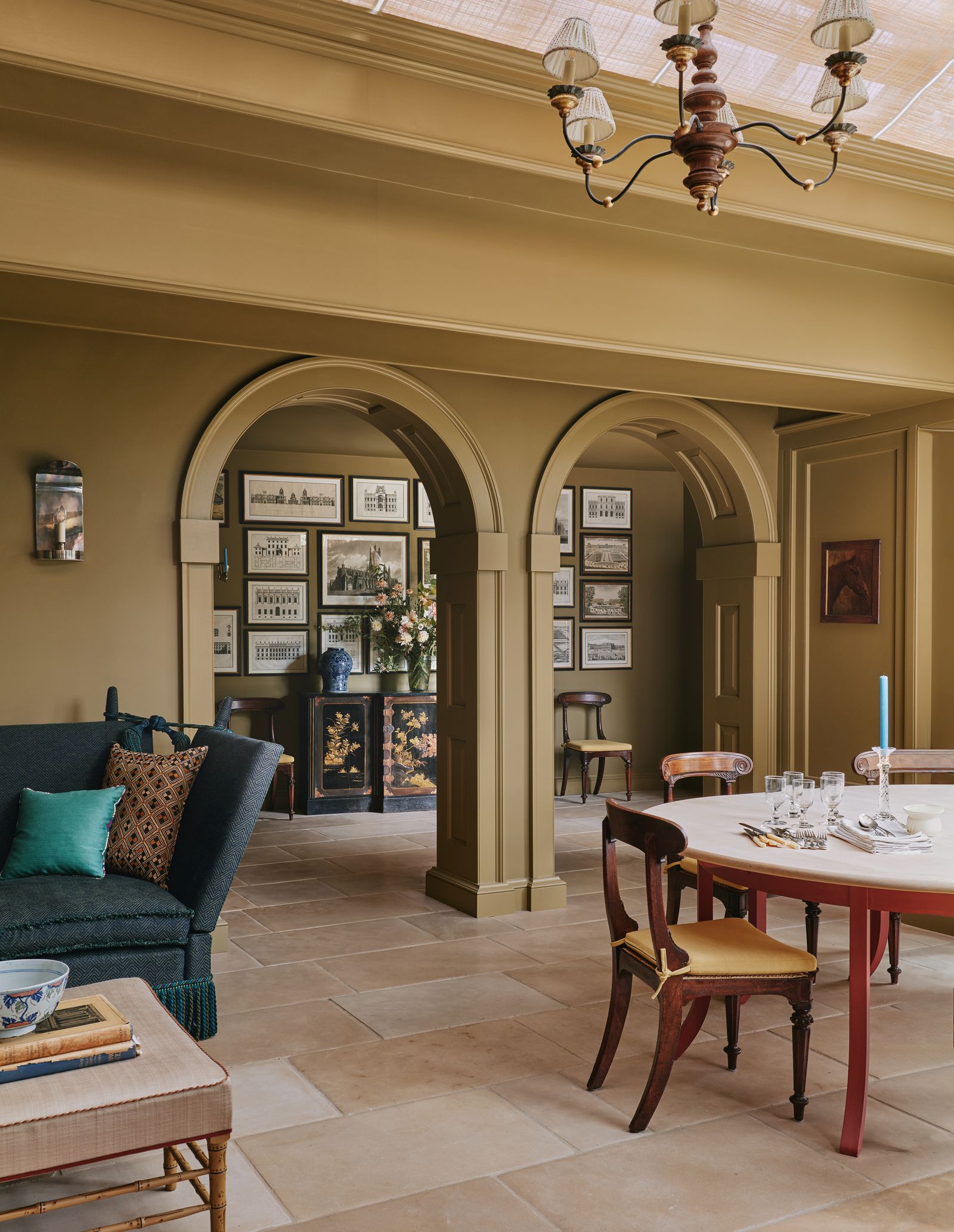 The kitchen leads into an orangery and inner orangery separated by arches with walls in a diluted version of Little...
