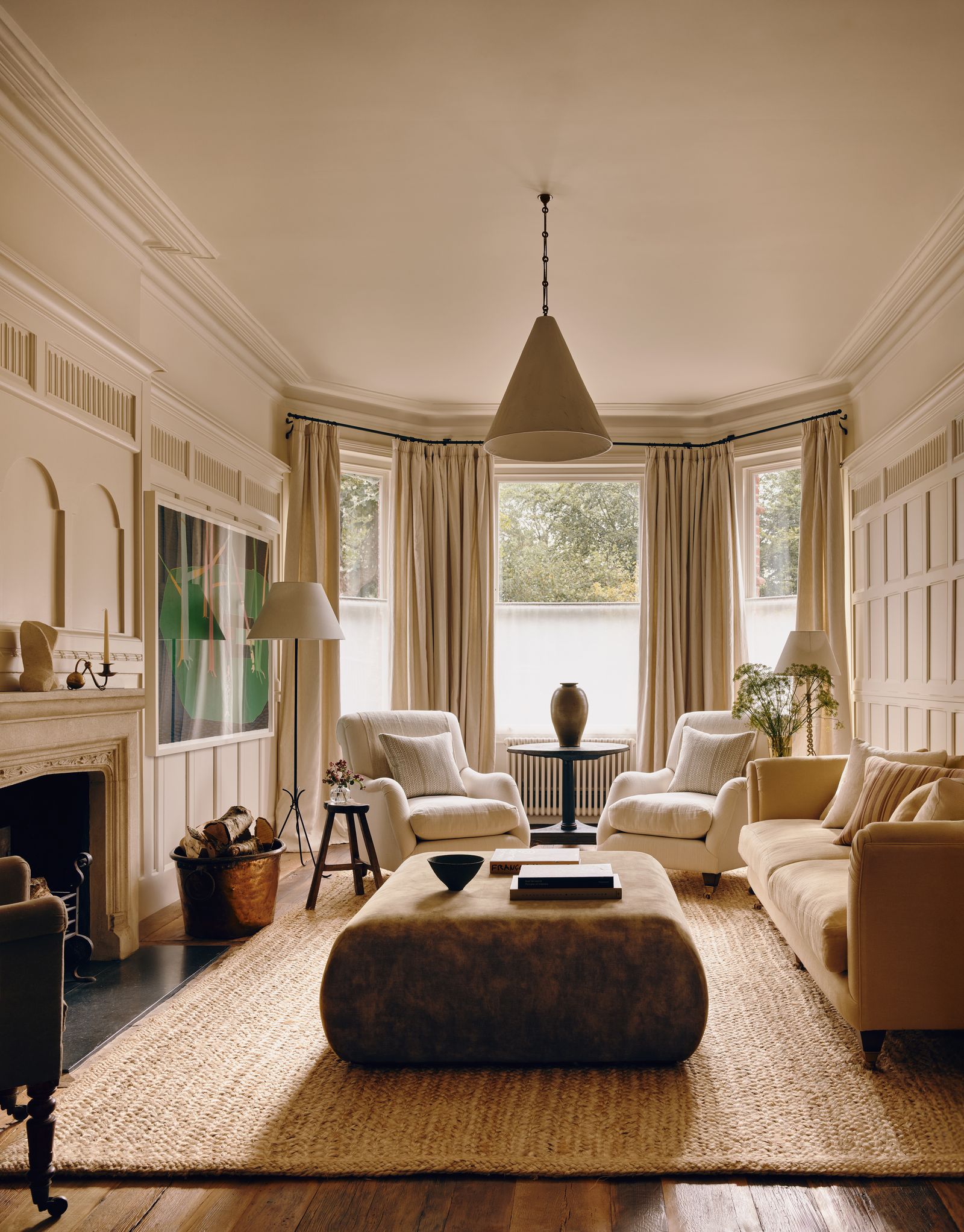 A Tom Hammick painting stands out in the living room providing a focal point for the bespoke sofa.