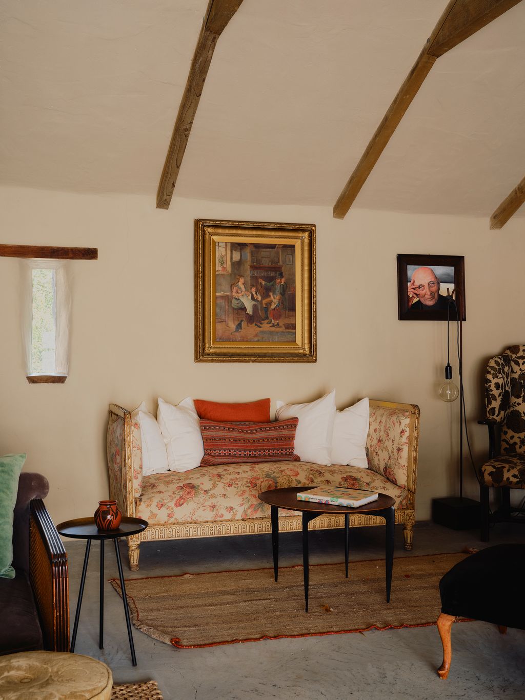 Jonny painted the portrait of the man hanging above the antique floral sofa. The low coffee table is vintage Fritz...