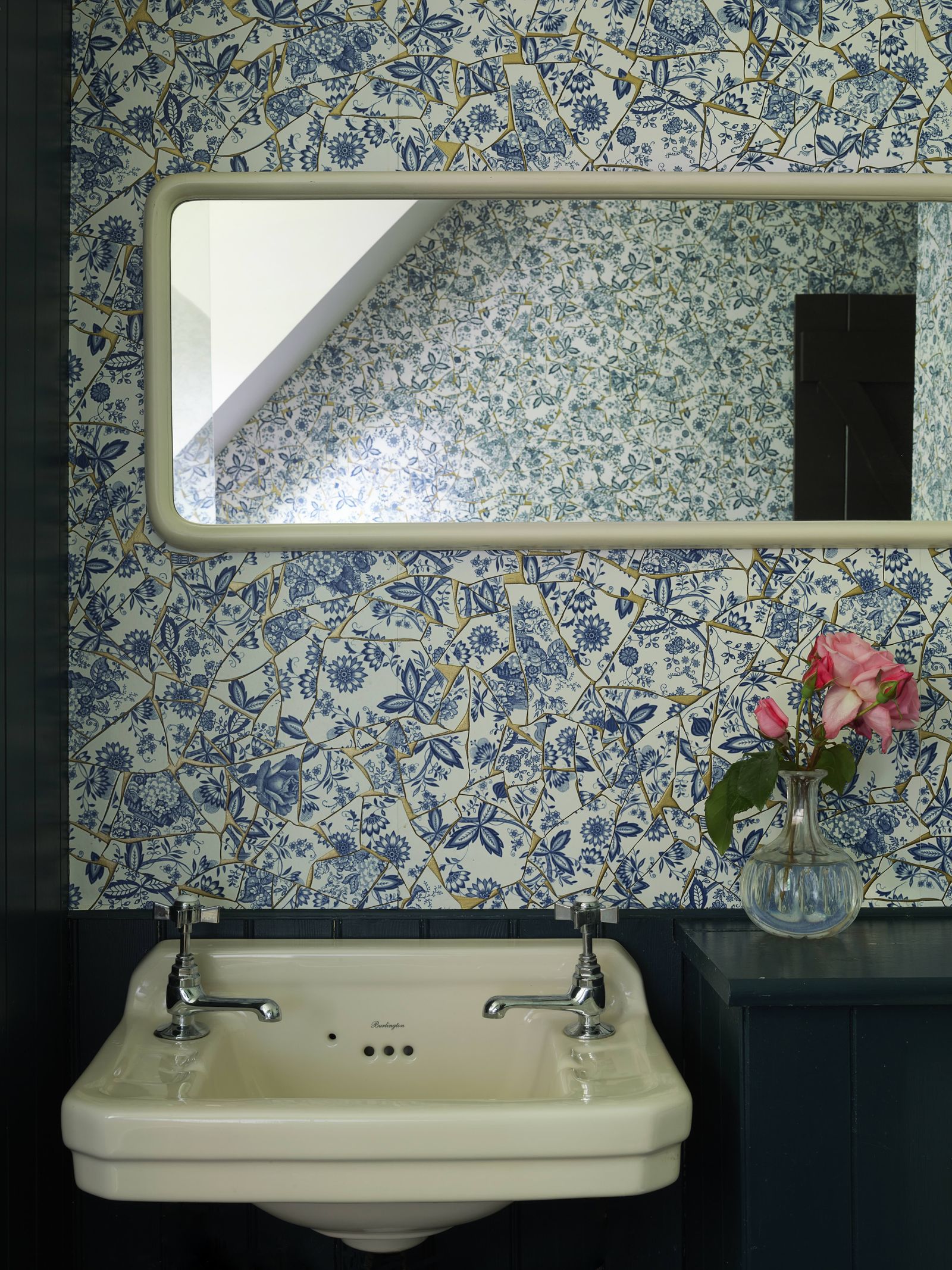 blue floral print wallpaper in washroom of Sienna Millers home white ceramic sink vanity rectangular mirror glass vase...