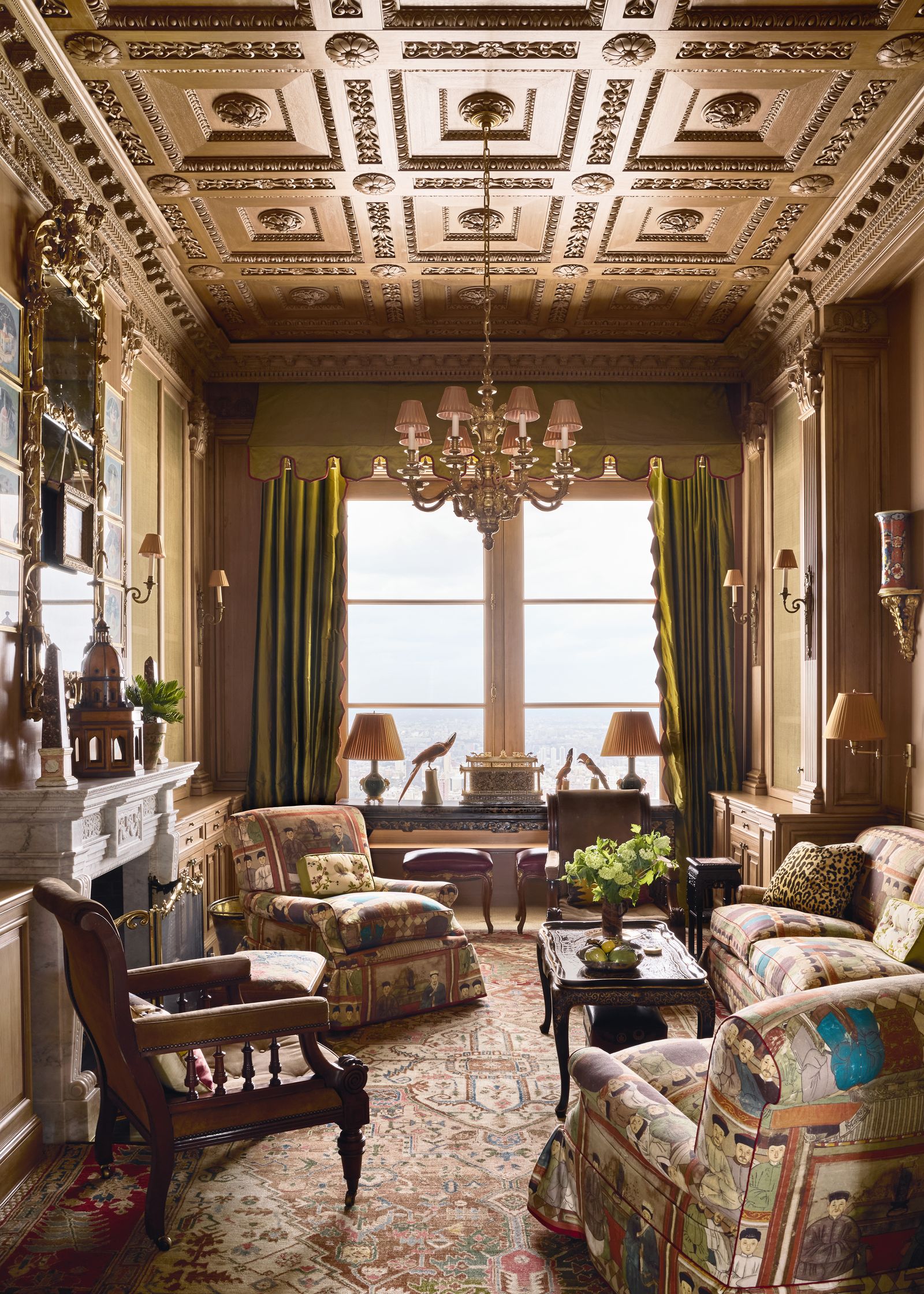 In the library the faux coffered ceiling and wooden panelling create an atmospheric setting for William IV mahogany...