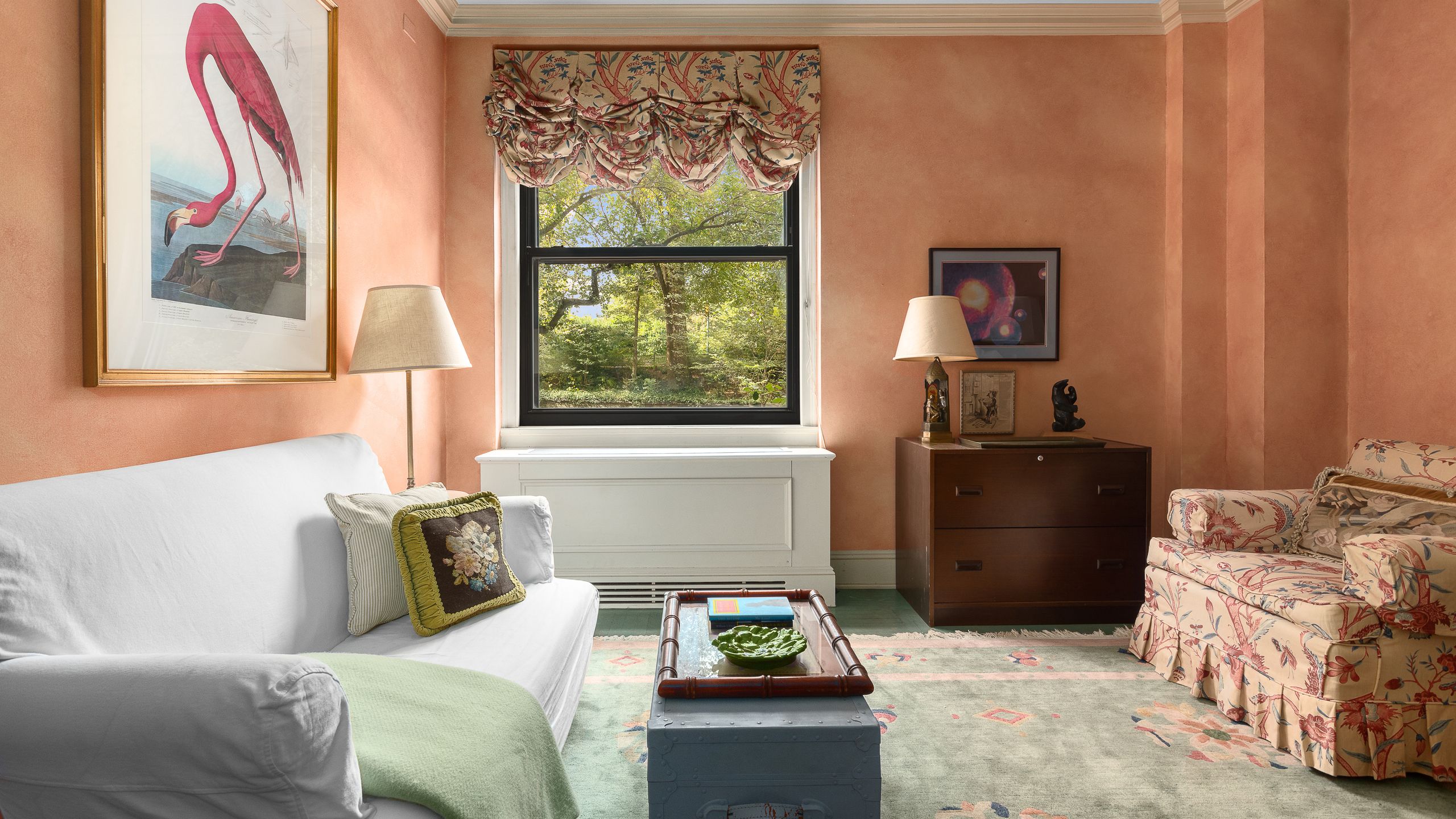 sitting area in Paul Newman and Joanne Woodwards NYC maisonette with salmonorange walls beige crown molding offwhite...