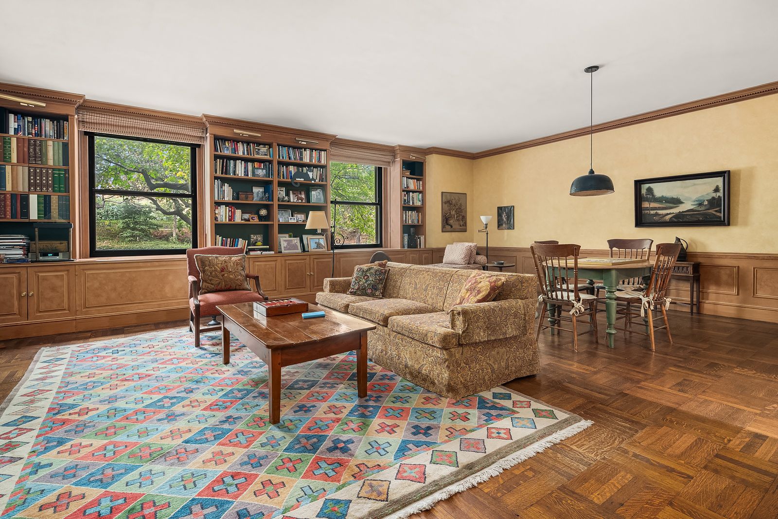 living and dining space in Paul Newman and Joanne Woodwards former NYC maisonette beige walls wood wainscoting pendant...