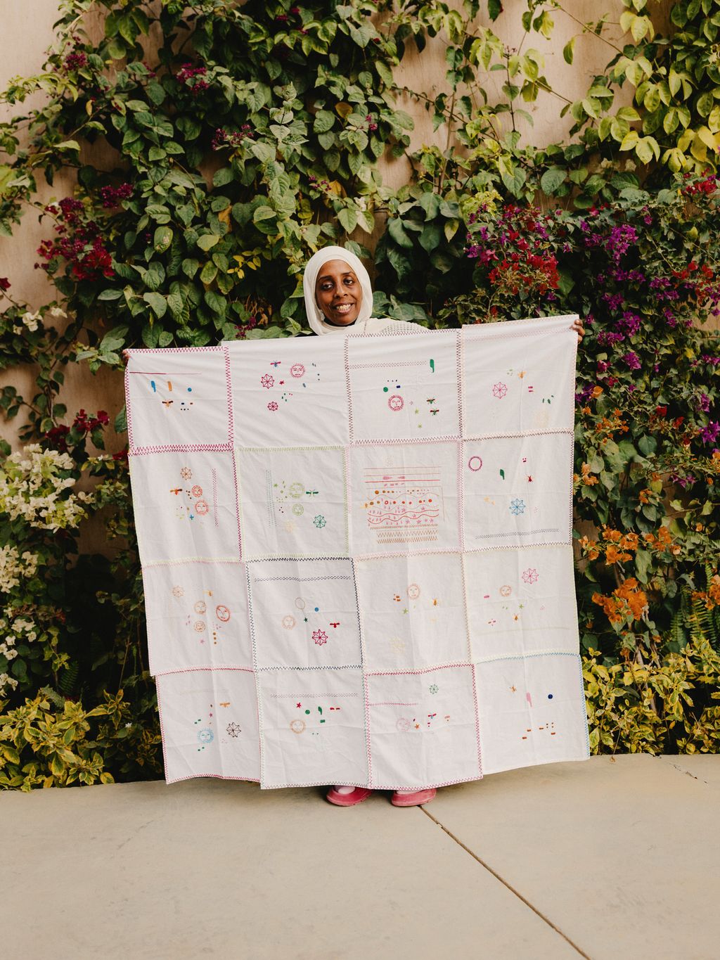 Samples department manager Jehan Magdi with work from the embroidery school.