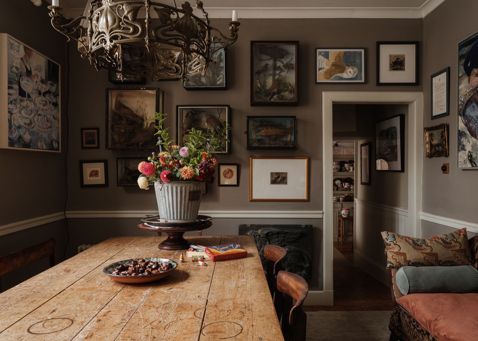 Another Art Nouveau light hangs over the dining table where dahlias from the garden catch the light. Mick's collection...