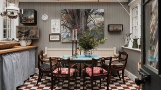 The conservatory leads off the kitchen a landscape by Brita takes centre stage on the back wall.