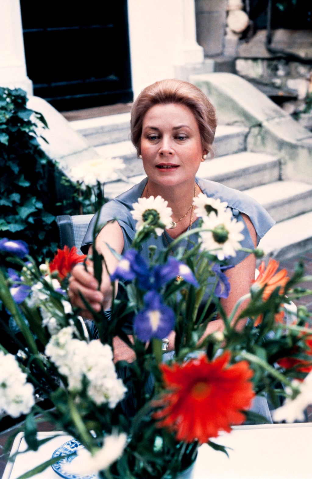 Grace Kelly arranging red white and purple flowers