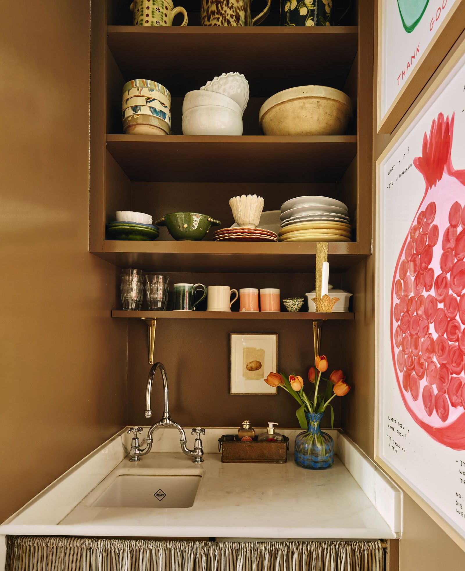 Shelves showcase vintage ceramics and David Shrigleys Untitled pomegranate