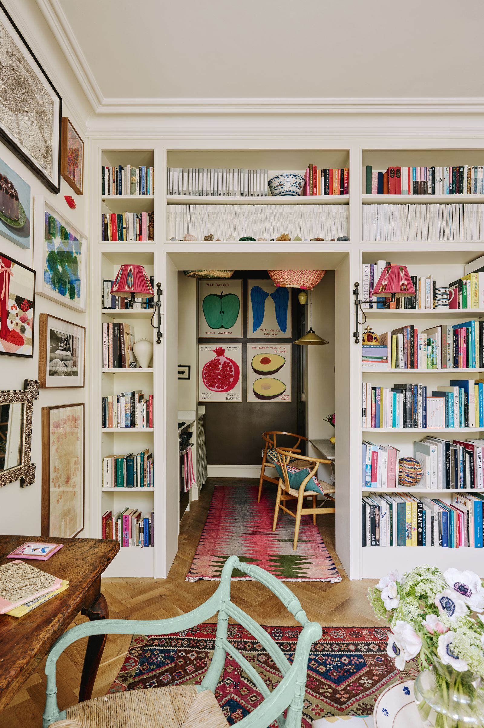 Looking through to the kitchen where four David Shrigley paintings create a bold display.