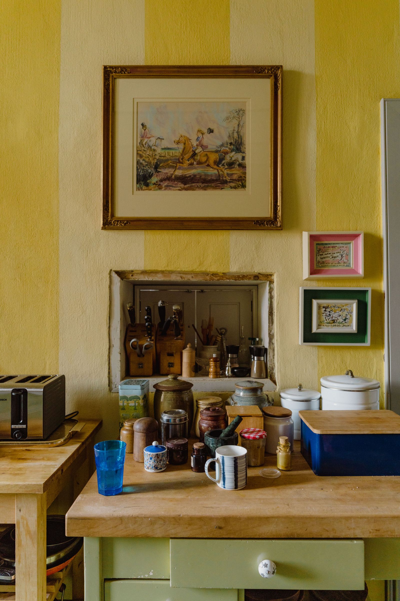 Image may contain Pottery Cup Shelf Indoors Interior Design Person Art Painting Dining Table Furniture and Table