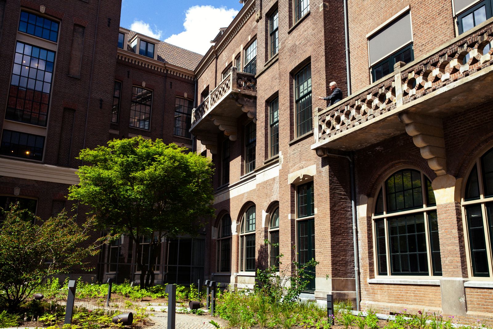 Image may contain City Urban Architecture Building High Rise Apartment Building Condo Housing Adult and Person