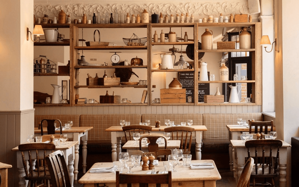 Image may contain Indoors Interior Design Cafe Restaurant Dining Table Furniture Table Architecture and Building