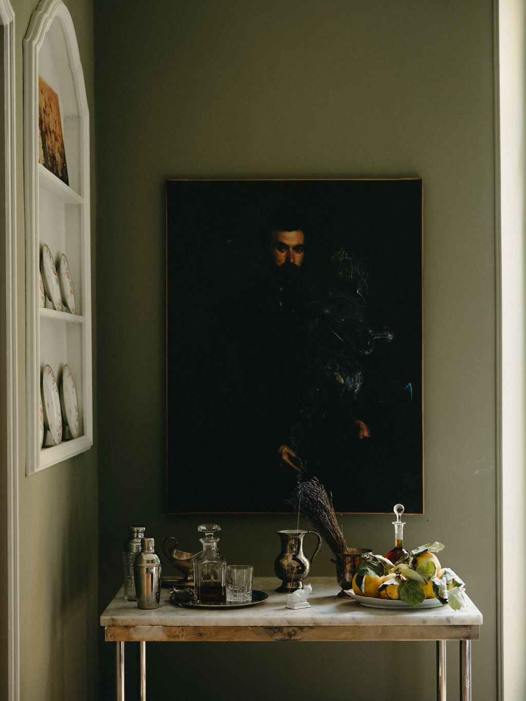 Image may contain Furniture Table Art Painting Adult Person Cup Face Head and Dining Table